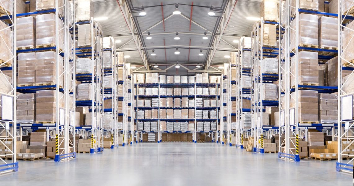 Huge distribution warehouse with high shelves and forklift. Bottom view.